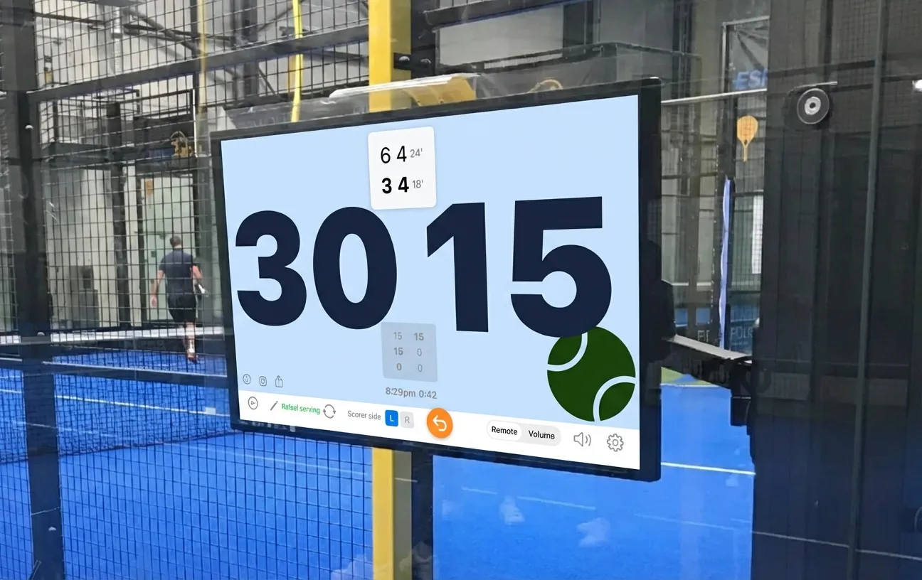 ScoreBot scoreboard displayed on a screen mounted courtside at a padel venue